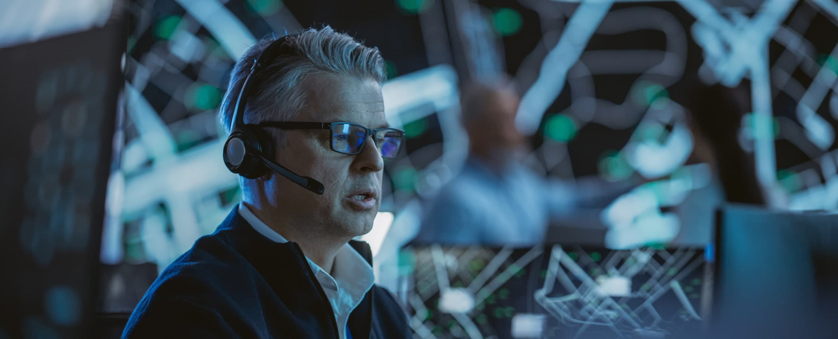 An account manager wearing a headset in a live operations center
